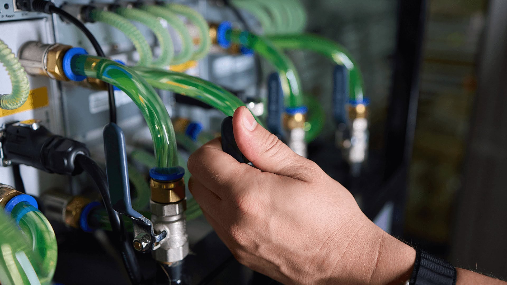 person installing a liquid cooling system in a data center